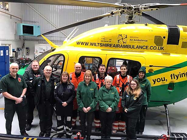 Whiteparish CFRs join aircrew and other staff in front of air ambulance